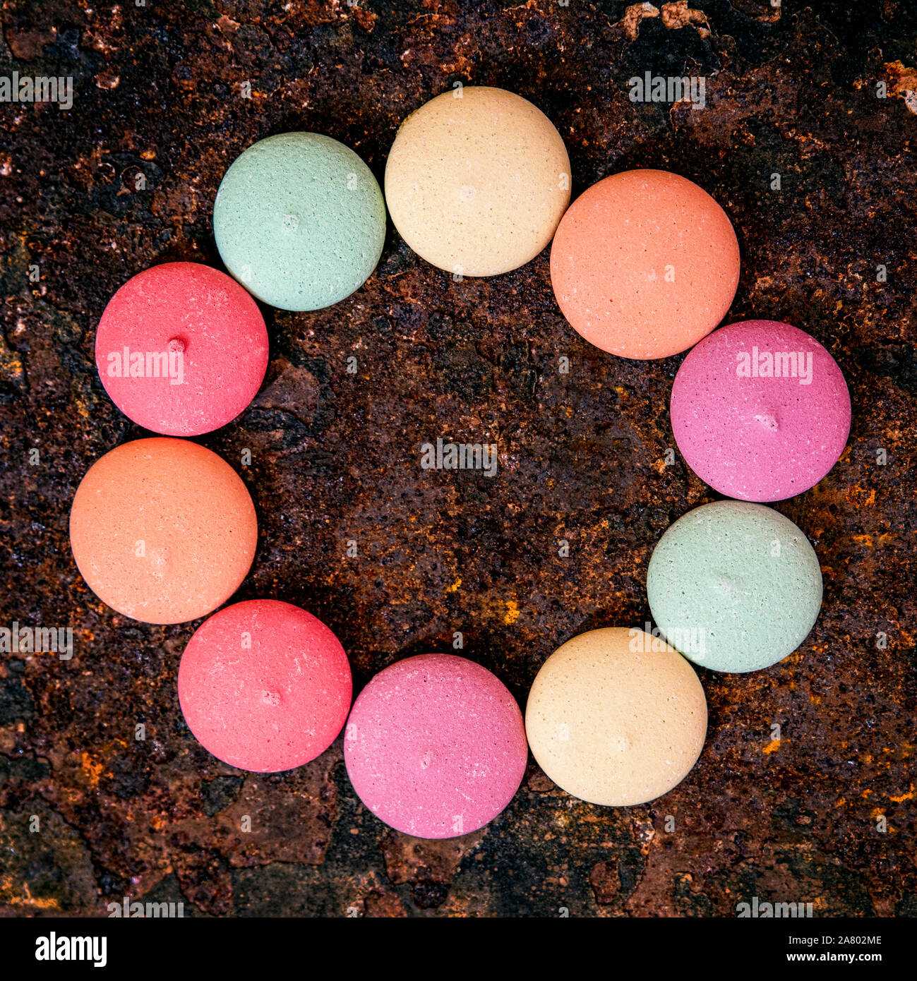Topview, sweet delicious and colorful cookies or biscuits on rusty background, candy circle Stock Photo