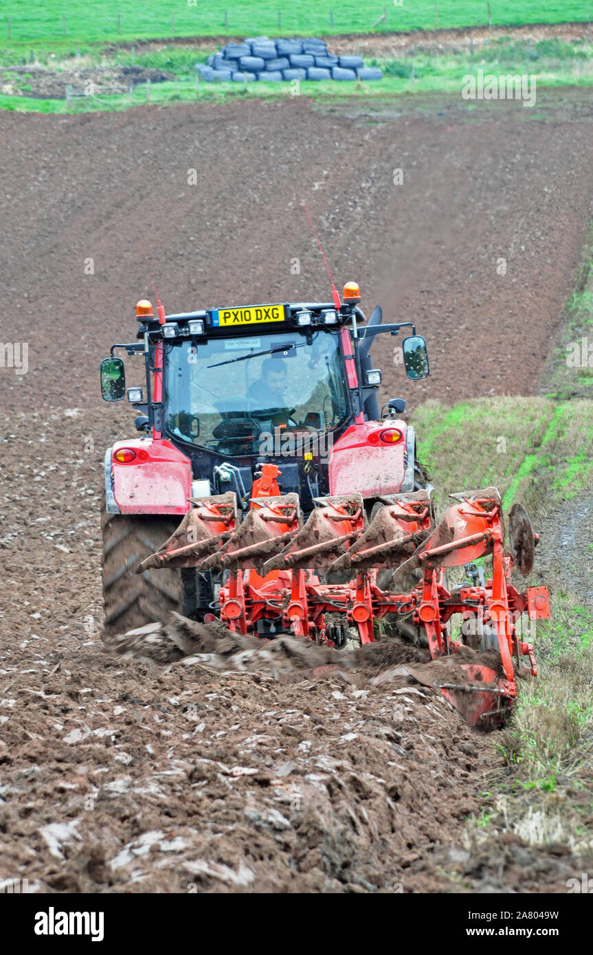 Ploughing by tractor Stock Photo Alamy