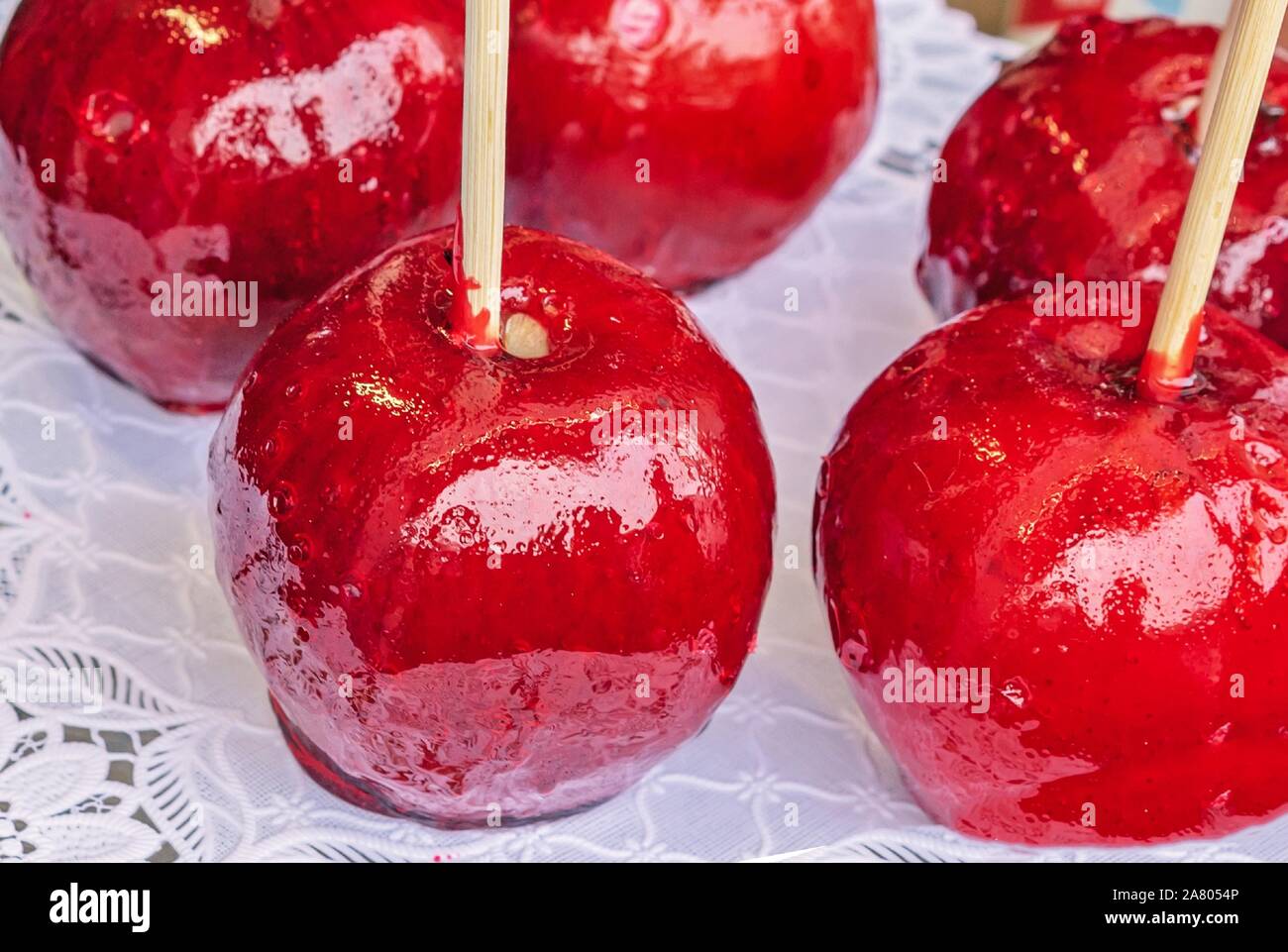 Candy Apple or Taffy Apple - red caramelized apples on a stick. Stock Photo