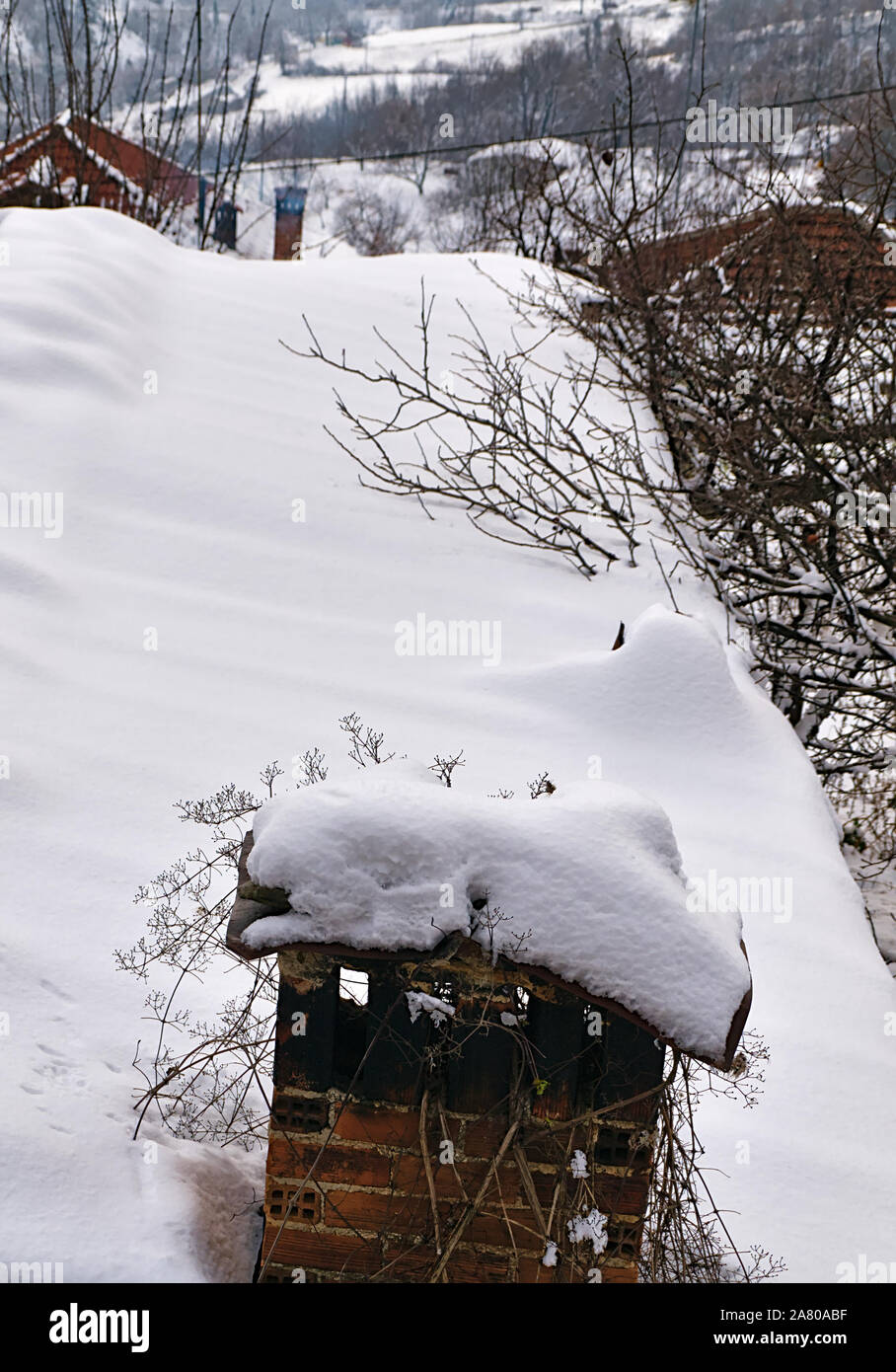 Snow covered village house roof and chimney Stock Photo - Alamy