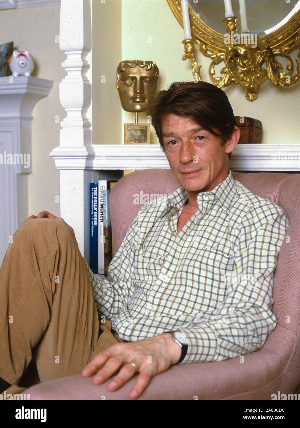John Hurt,actor at home in Chiswick with his Best Actor BAFTA award for the in the film The Elephant Man Stock Photo