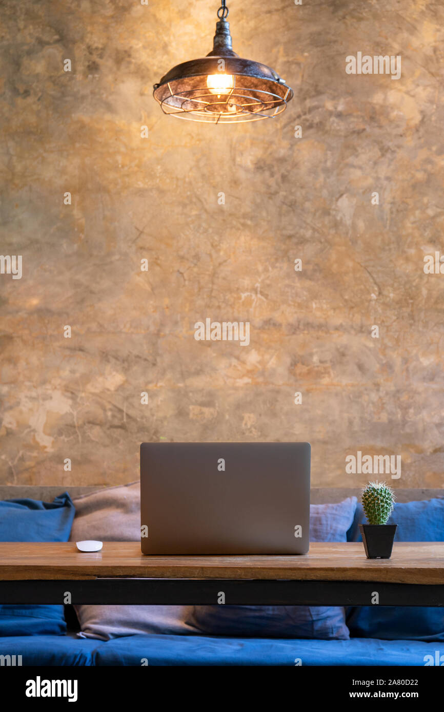 Office working equipment laptop with mouses and cactus plant on table in cafe. Stock Photo