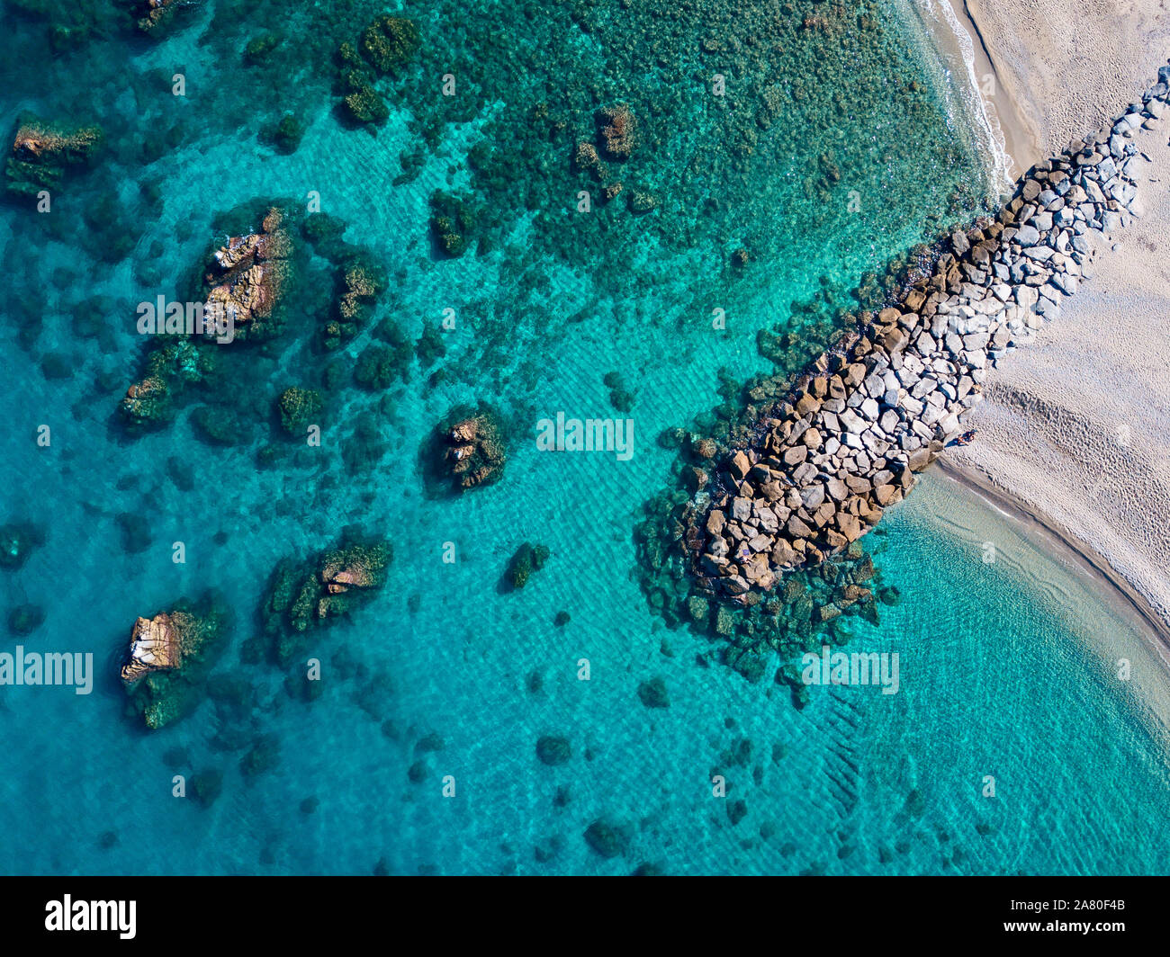 Aerial view of Tropea beach, crystal clear water and rocks on the beach ...