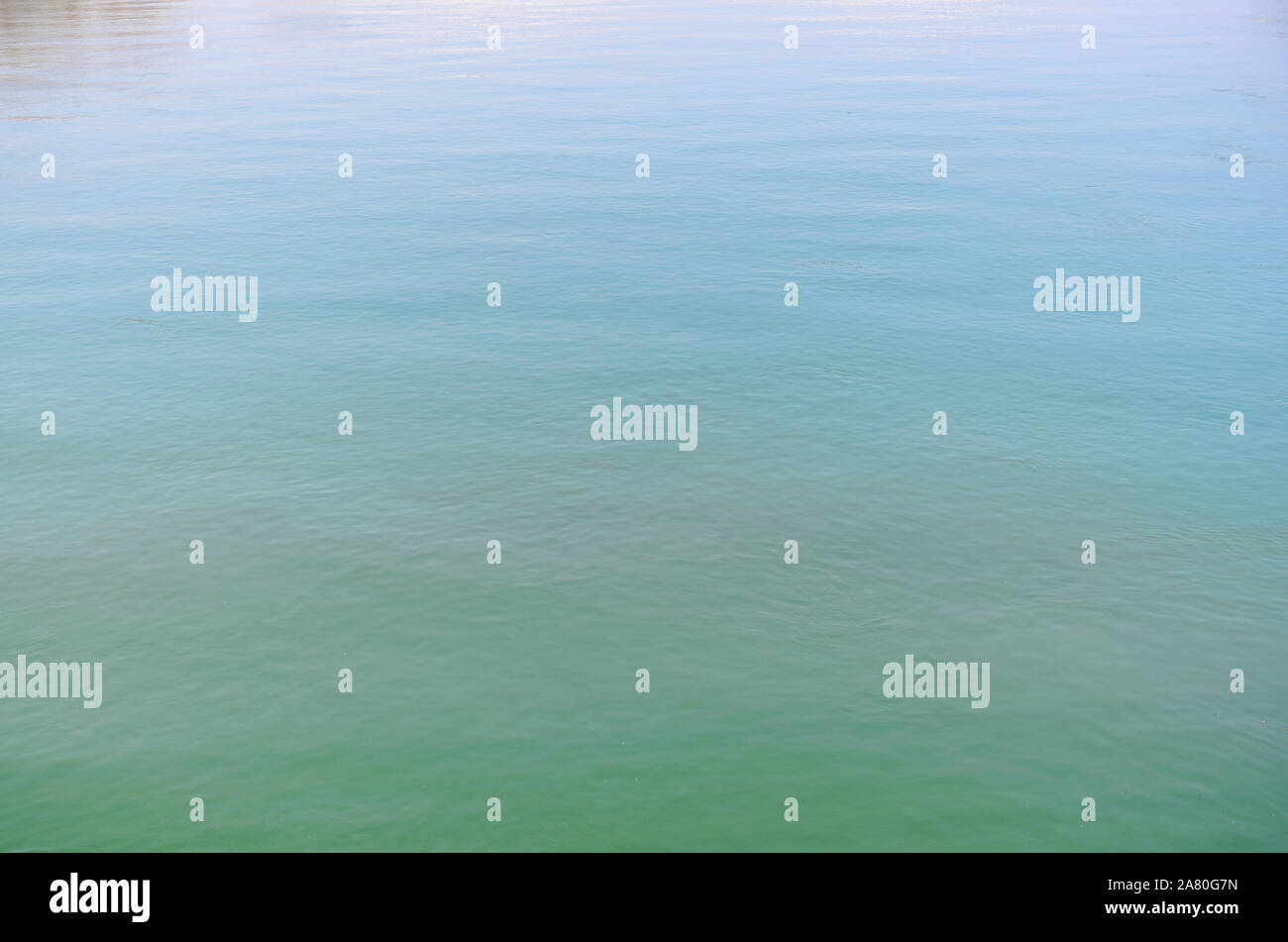 Background texture of tranquil rippling blue-green water in a full frame view Stock Photo