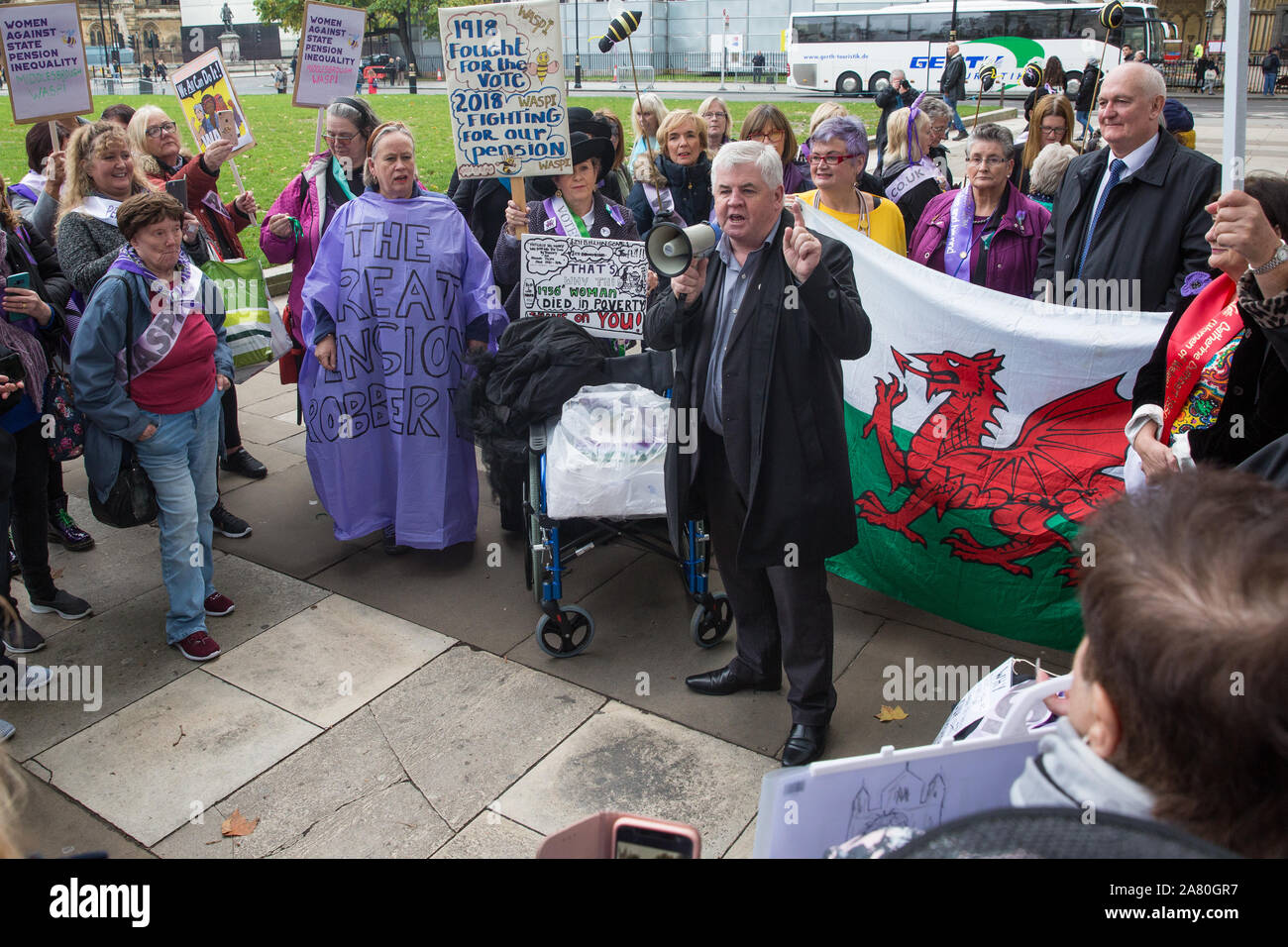 London, UK. 5 November, 2019. Hugh Gaffney, Scottish Labour MP for Coatbridge, Chryston and Bellshill, addresses campaigners from WASPI (Women Against State Pension Inequality) protesting in Parliament Square to call for fair transitional pension arrangements for women born in the 1950s affected by the changes to the State Pension Age (SPA), including a 'bridging' pension to provide an income from age 60 until State Pension Age and recompense for losses incurred by women who have already reached their SPA. Credit: Mark Kerrison/Alamy Live News Stock Photo