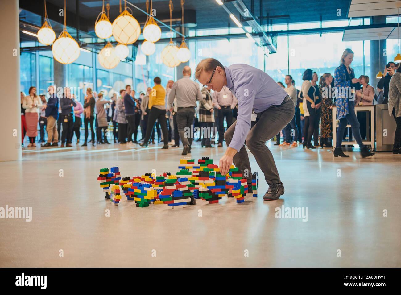 Lego Employee building Lego Challenge Stock Photo