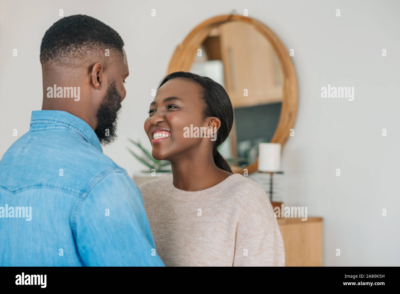 Loving African American couple hugging each other at home Stock Photo ...