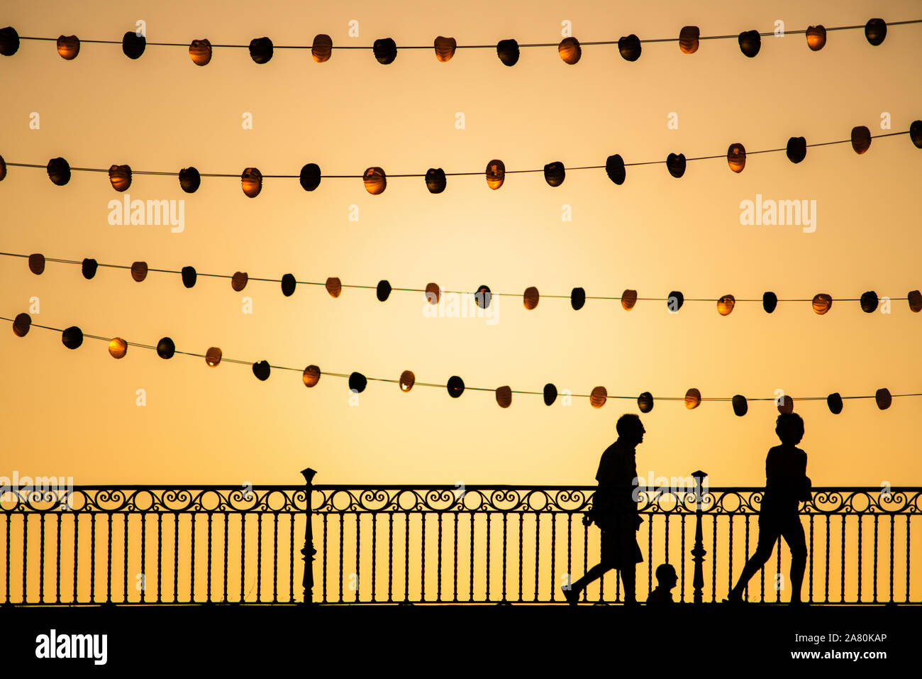 Pedestrians on Triana bridge during Vela de Santa Ana festival, Seville, Spain Stock Photo