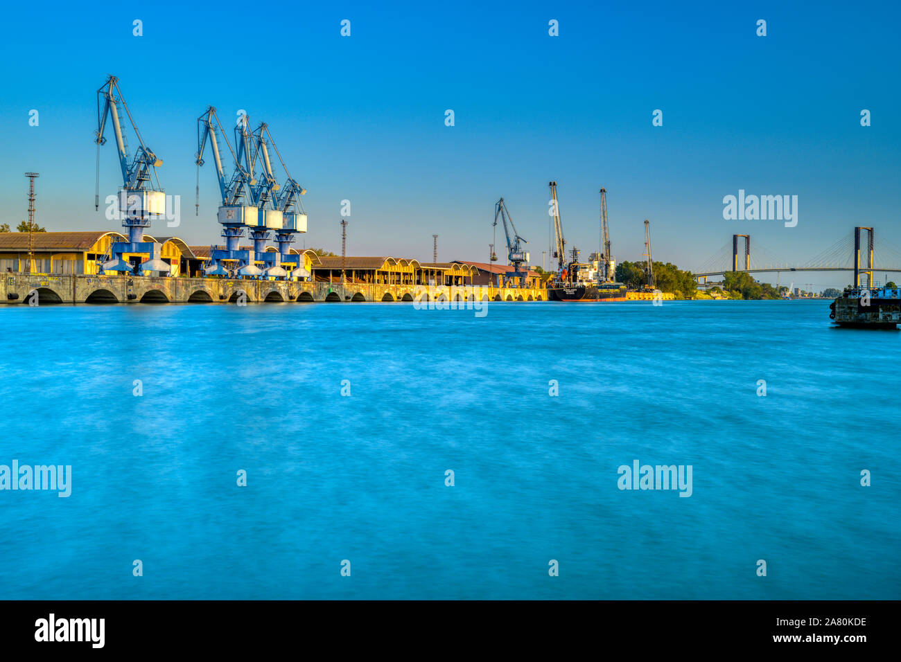 Single jib portal cranes, facilities of the river port of Seville, Spain. Stock Photo