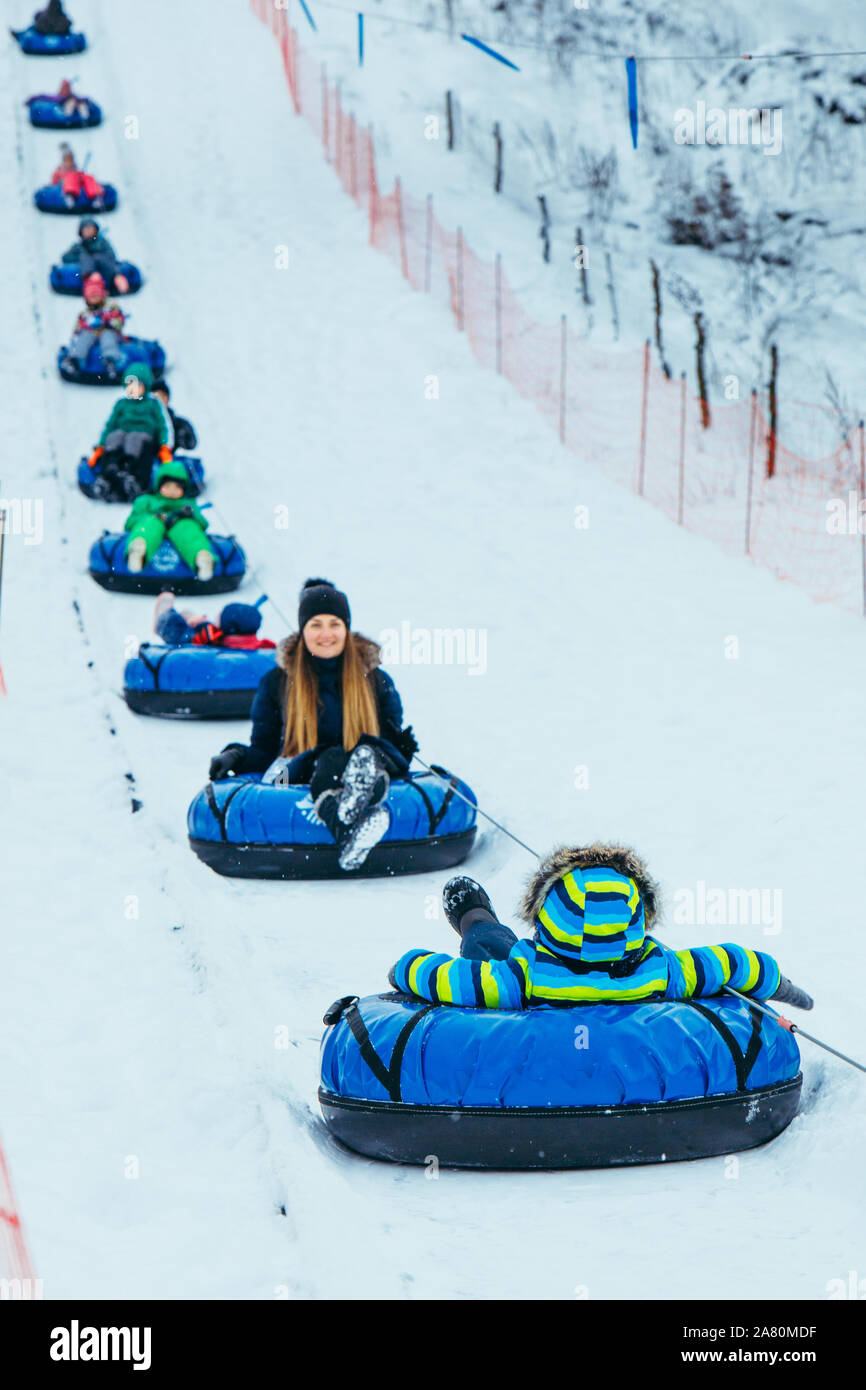 snowing tubes pulling up by hill. families leisure time Stock Photo Alamy
