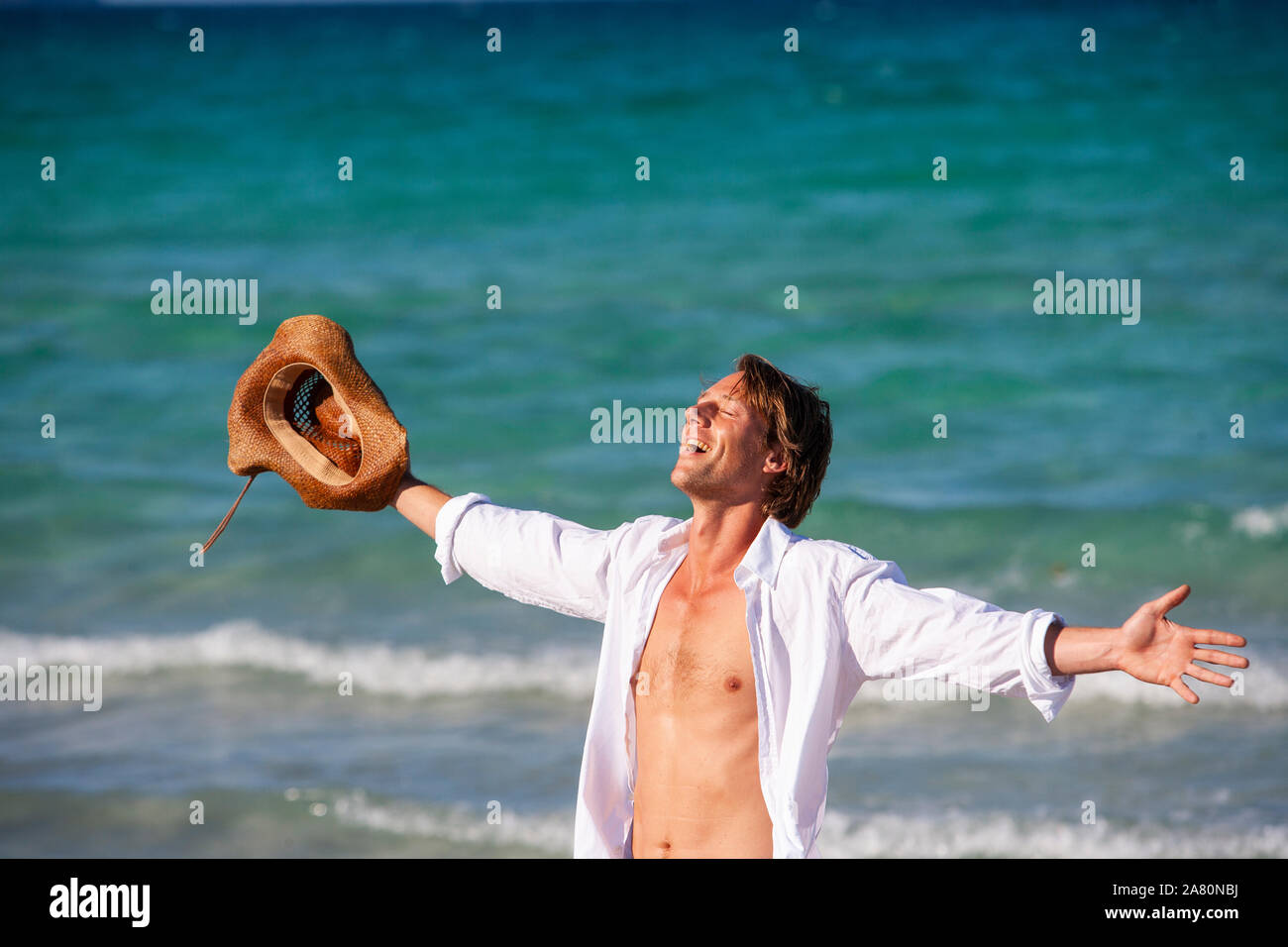 Ecstatic young man on a beach Stock Photo