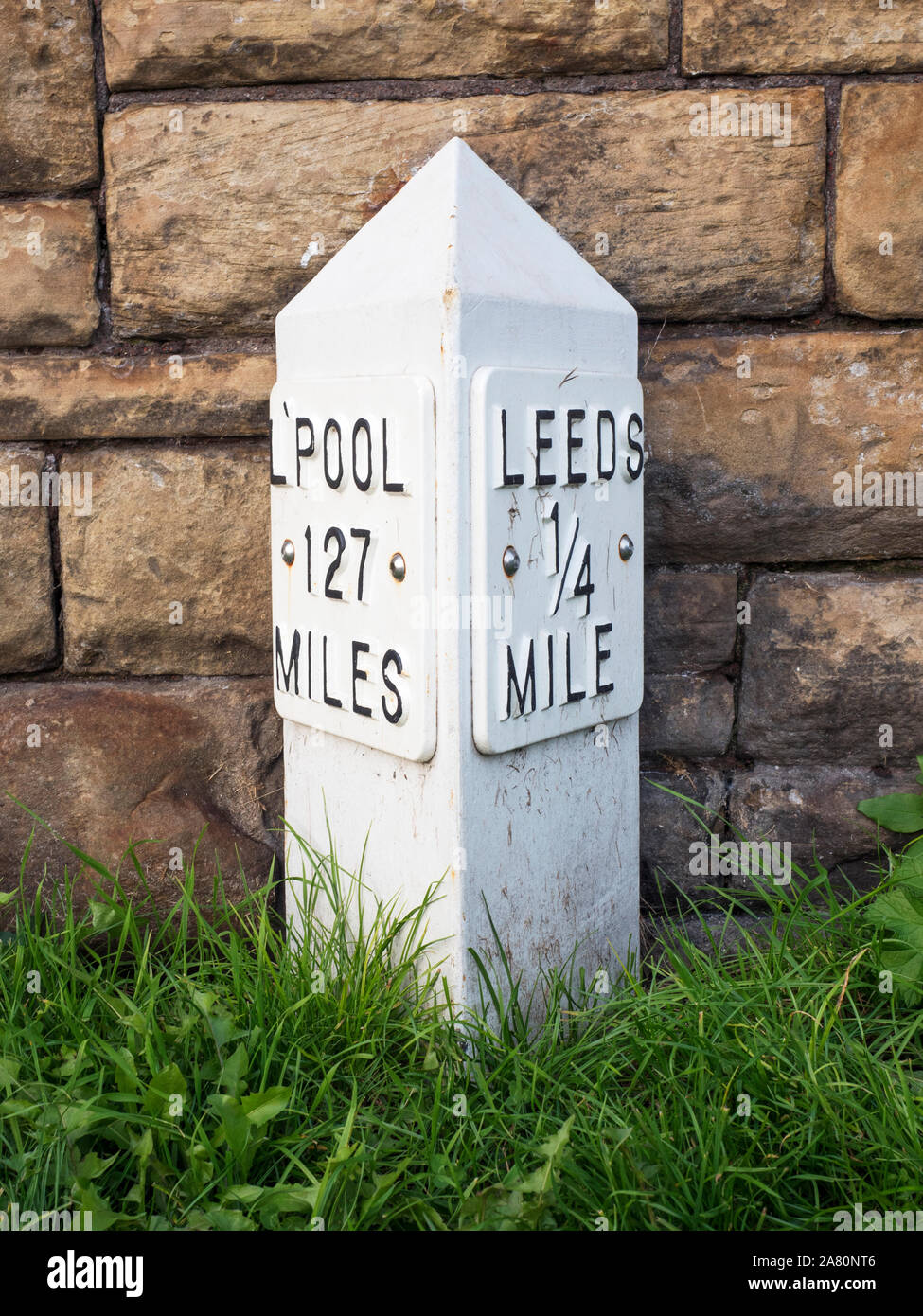 Leeds quarter mile Liverpool 127 miles milepost on the Leeds and Liverpool Canal at Leeds West Yorkshire England Stock Photo