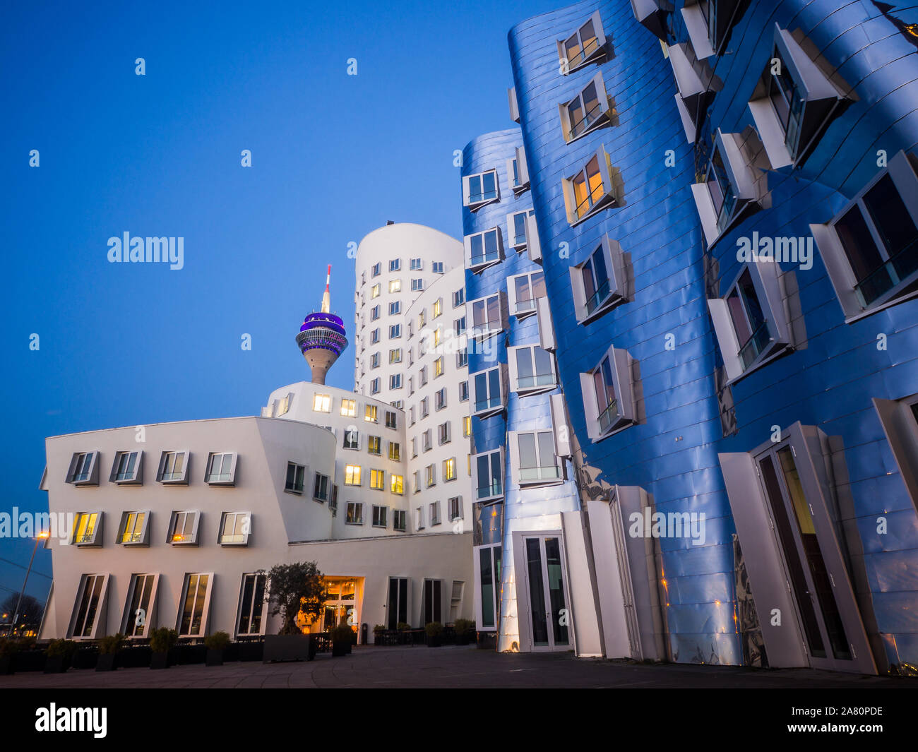 Neuer Zollhof buildings from Frank Gehry in Dusseldorf, Germany. First lights at evening. Modern architecture in Europe. Stock Photo