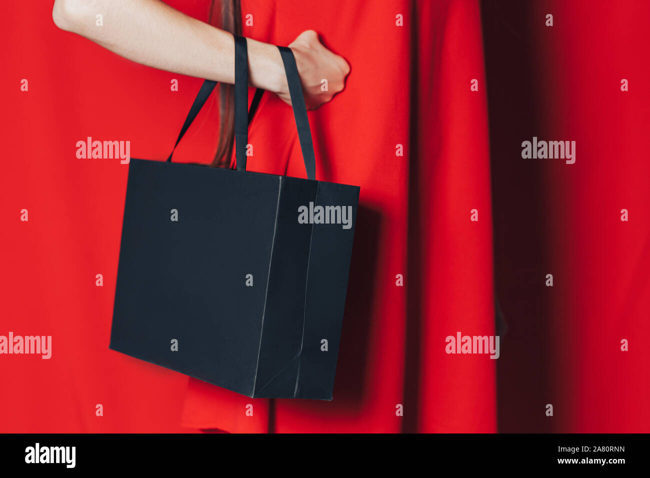 woman in red dress black bag Stock Photo Alamy