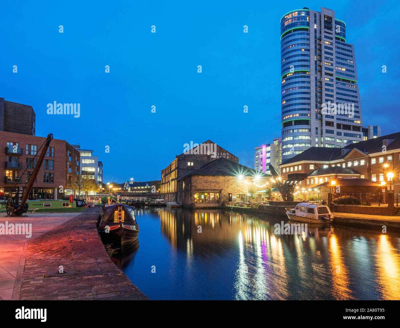 Bridgwater Place reflected in the Leeds and LIverpool Canal at Granry Wharf at dusk Leeds West Yorkshire England Stock Photo