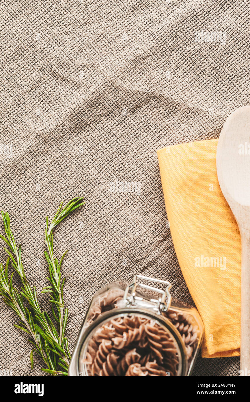 raw wholegrain Italian pasta on a linen cloth in the kitchen