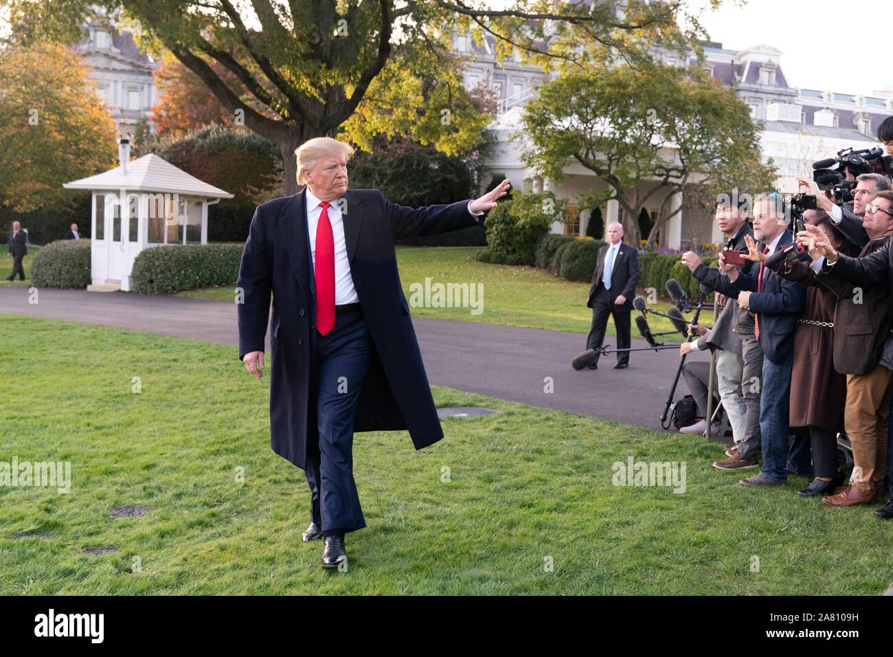 Washington, United States of America. 04 November, 2019. U.S. President Donald Trump waves to members of the media prior to boarding Marine One to begin his trip to Kentucky on the South Lawn of the White House November 4, 2019 in Washington, DC.  Credit: Joyce Boghosian/White House Photo/Alamy Live News Stock Photo