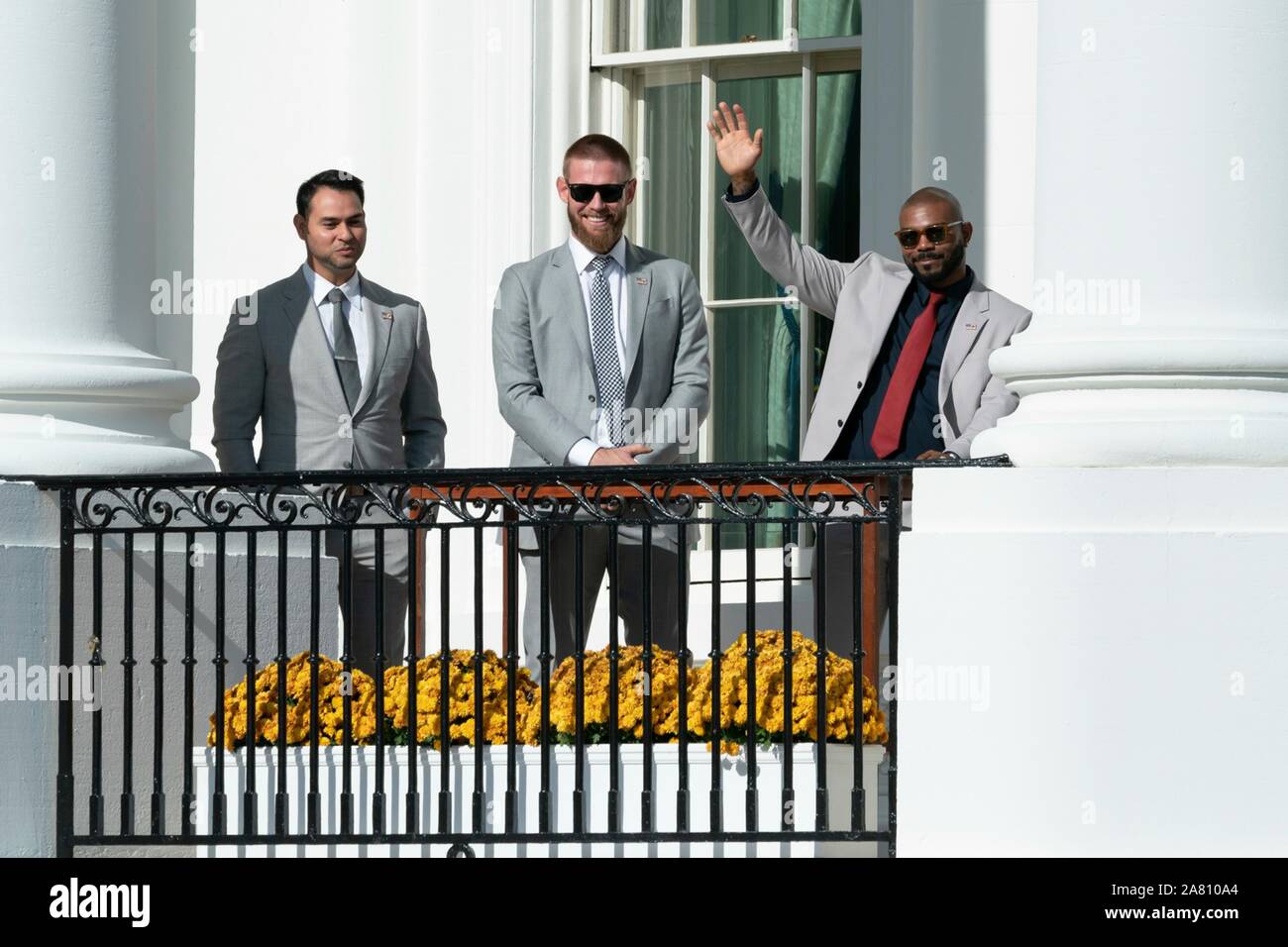 Washington, United States of America. 04 November, 2019. Washington Nationals infielder Howie Kendrick, right, waves alongside fellow teammates on the South Portico balcony of the White House November 4, 2019 in Washington, DC. The 2019 Baseball World Series Champions attended an event in their honor by U.S. President Donald Trump to celebrate their victory.  Credit: Andrea Hanks/White House Photo/Alamy Live News Stock Photo