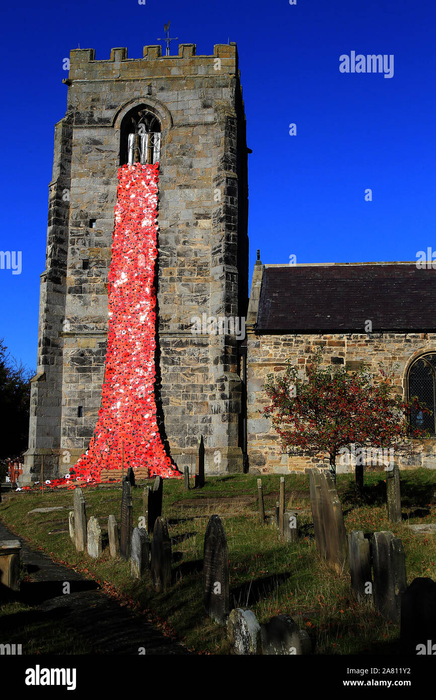 Poppy installation at Hope Parish Church.  Monday 29th October 2018. A poignant poppy display has been crafted by a community to mark 100 years since the end of the First World War.  The cascade that can be seen pouring down from the tower of Hope Church in Flintshire features a blanket of more than 2,000 poppies.  The giant artwork features handcrafted laminated flowers, each made by members of the community from primary schoolchildren to youth groups, play schools and high school students.  Stretching from the top of the tower and down into the cemetery below, it is about to grow even bigger Stock Photo