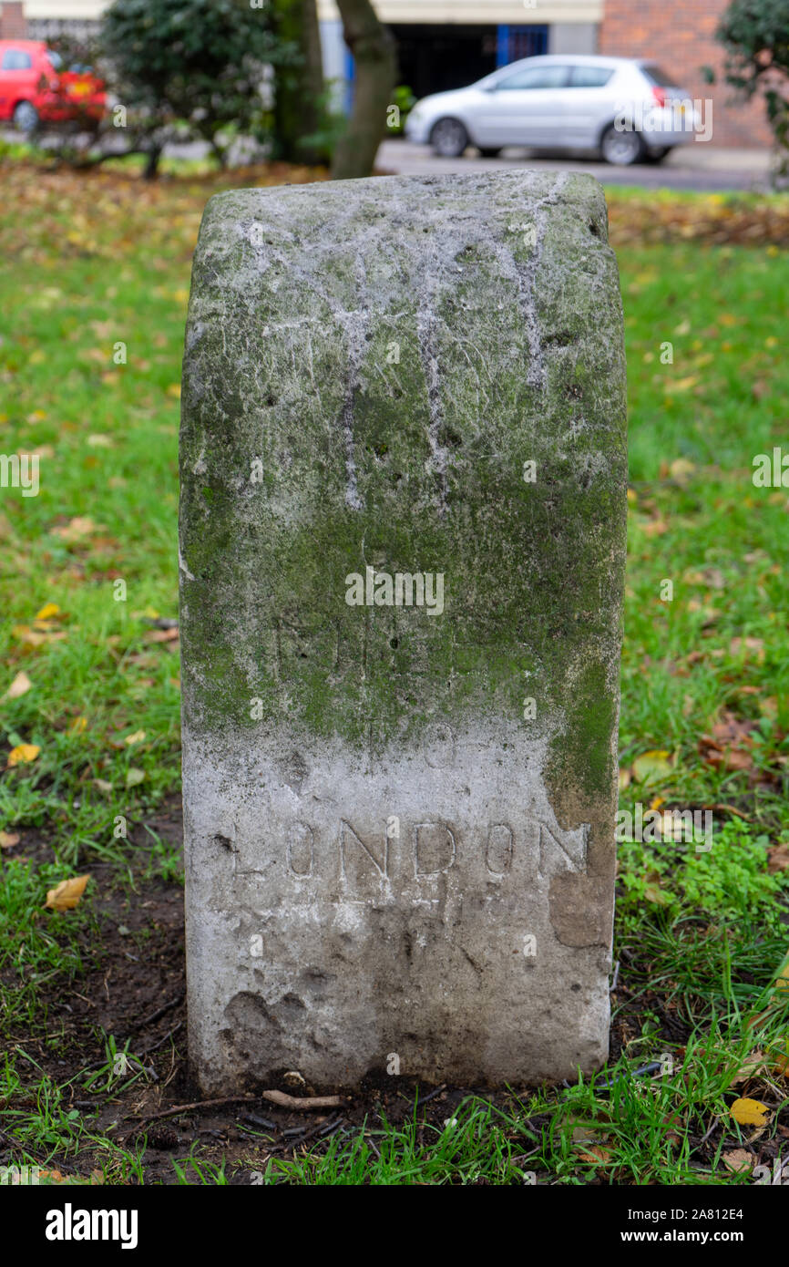 an old milestone marker showing how many miles to london from portsmouth Stock Photo