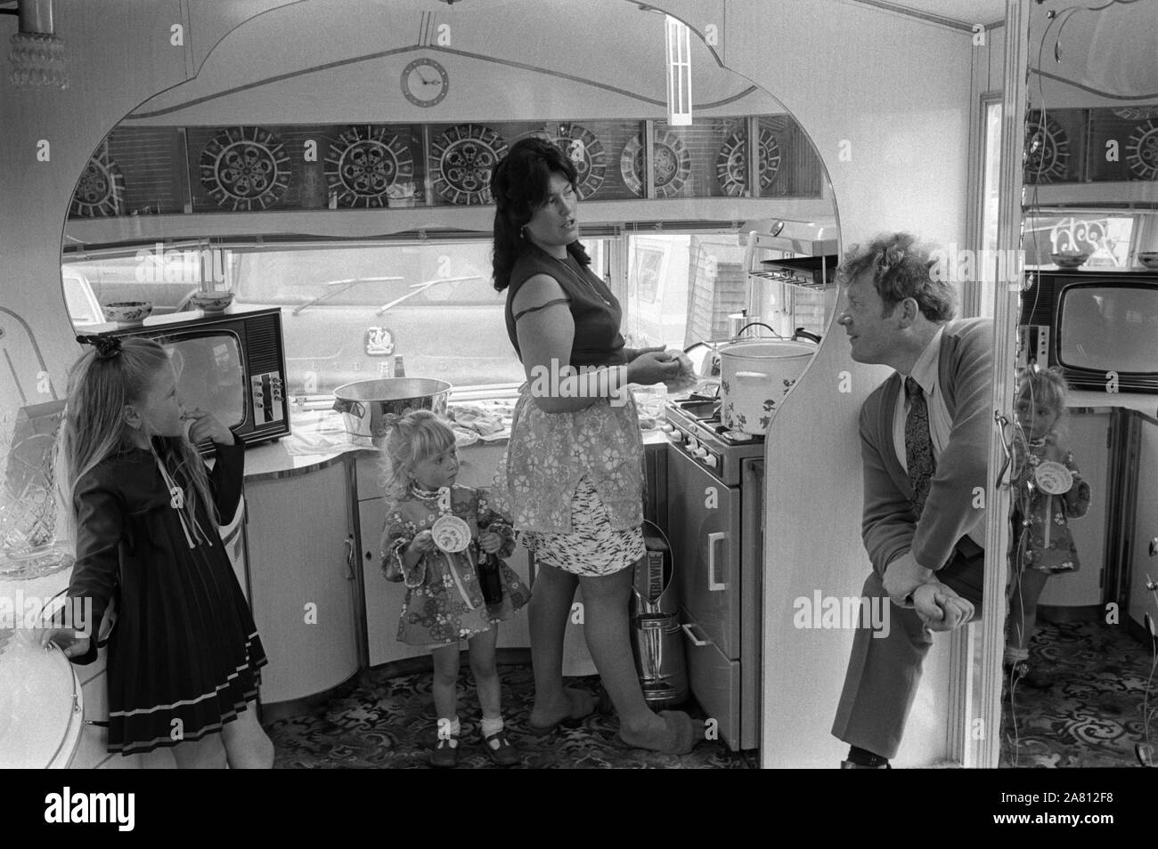 Interior of gypsy caravan 1970S. The kitchen area, there is no running water as it is considered unlucky. Mother two daughter and father at the Derby Day horse race, Epsom Downs England. 1974 HOMER SYKES Stock Photo