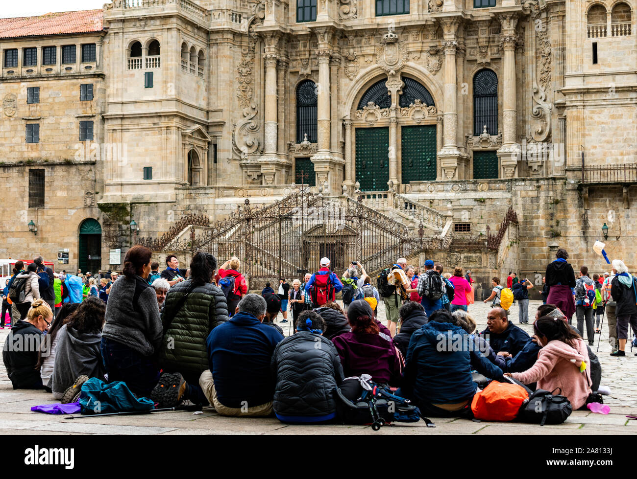 Pelegrins. Group of people praying in front of Cathedral Santiago de Compostela. Spain Stock Photo