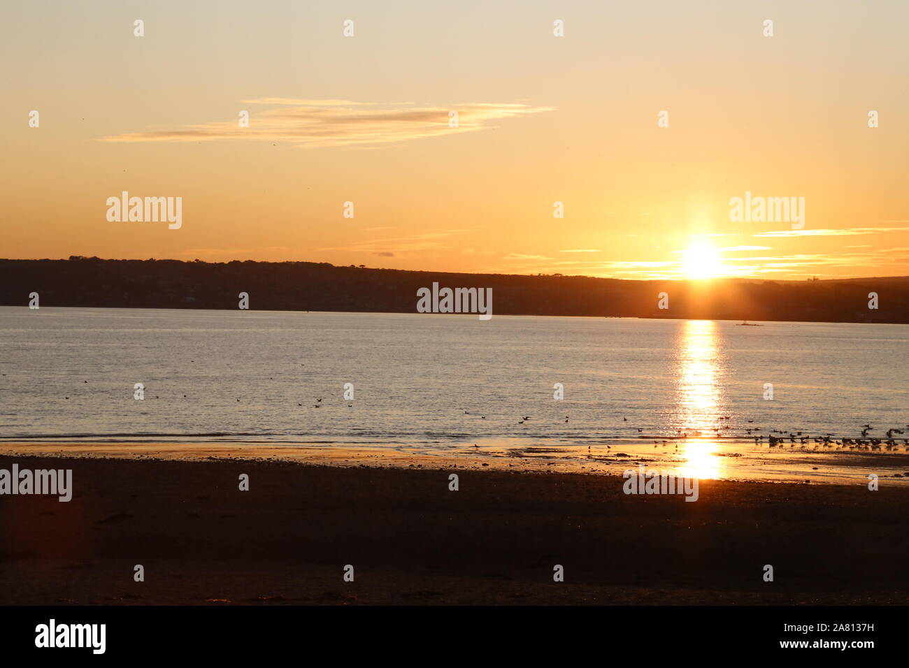 Sun setting over sea Stock Photo