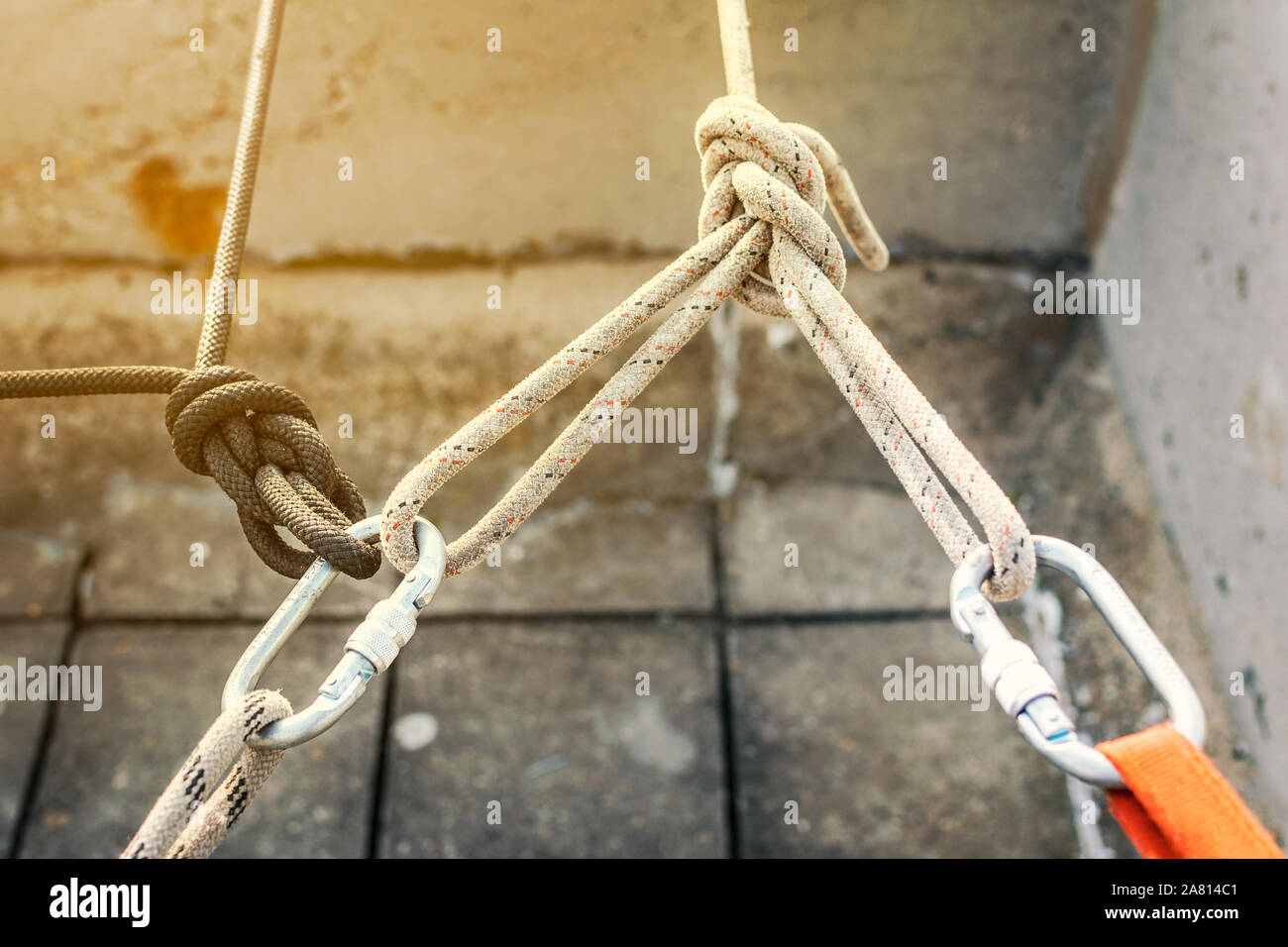 Industrial climbing work site. Rope access working and equipment on top of  the high city building. Rope anchoring points and knots with metal carabine  Stock Photo - Alamy