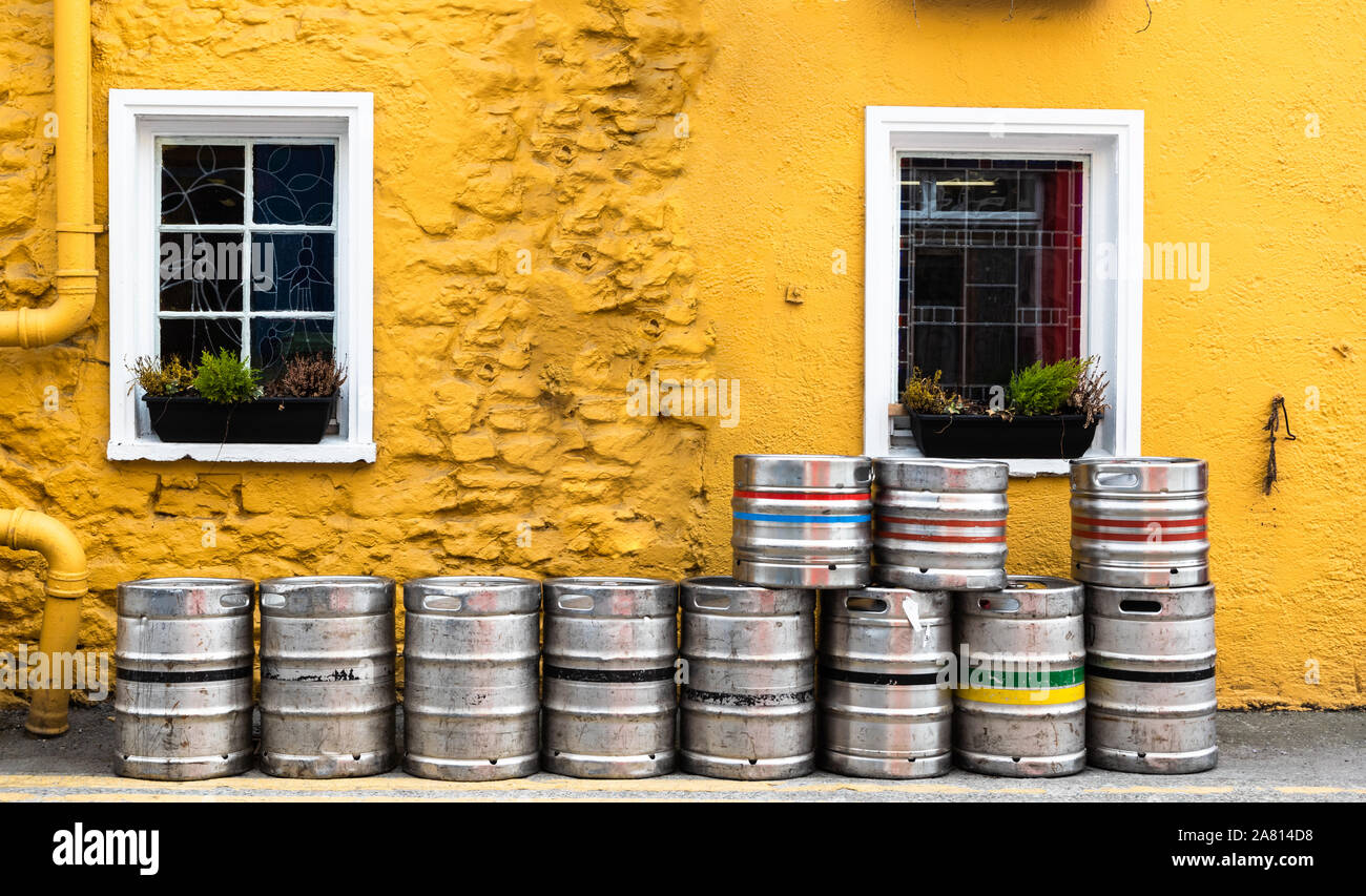 Beer kegs outside the side entrance of old Irish bar in rural Ireland Stock Photo