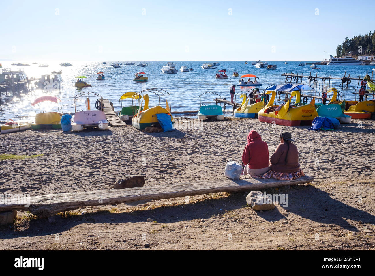 Local people and duck-shaped boats in Copacabana beach, Bolivia Stock Photo