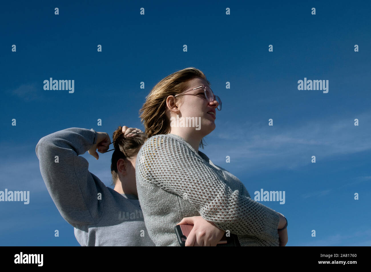 Two young standing wih sky in background Stock Photo