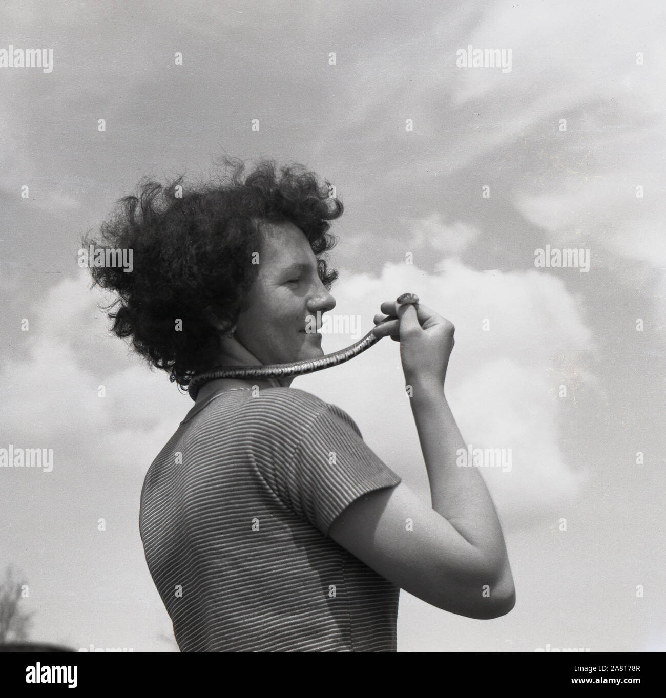 1960s, historical, outside, a lady with a small snake around her neck. Stock Photo