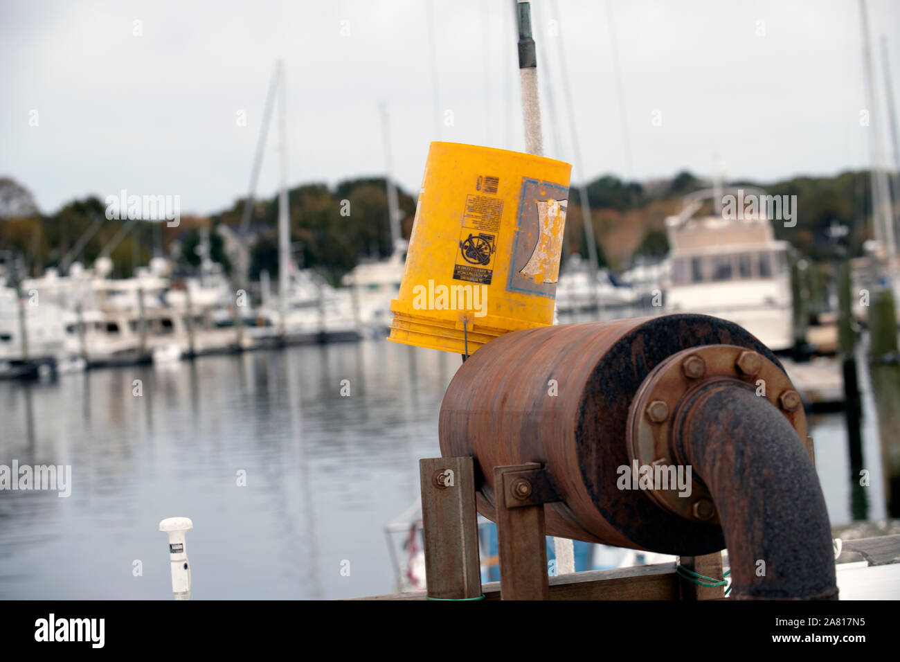 Yellow bucket on boat in harbor Stock Photo