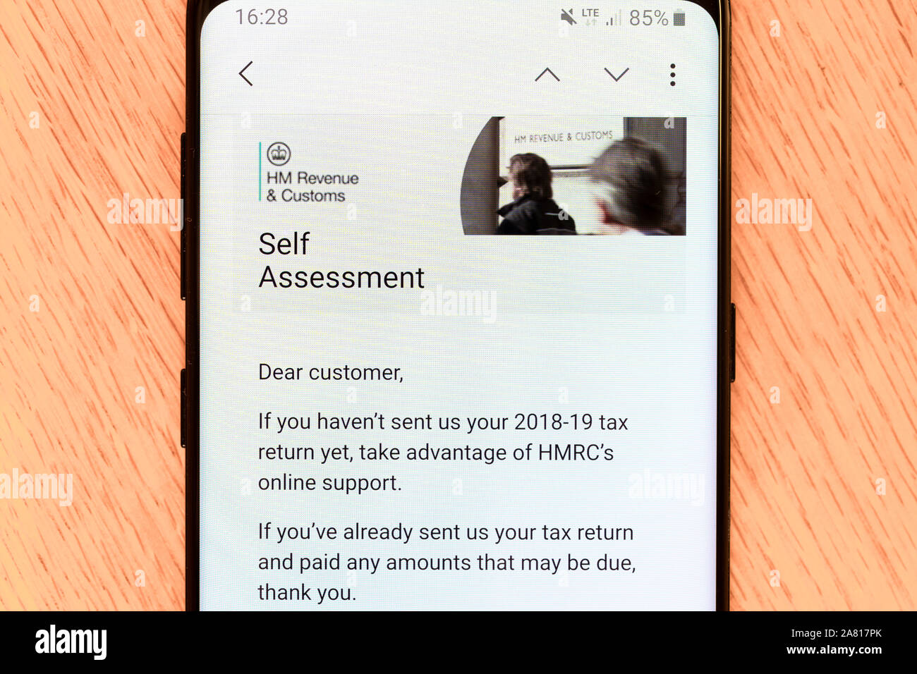 An email on a smartphone from the UK HM Revenue and Customs asking for a self assessment tax return to be submitted for the 2018 - 2019 tax year Stock Photo