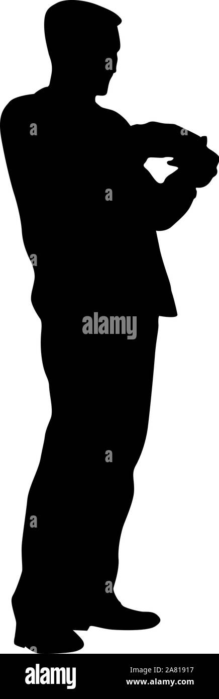 A man stands with his hands in front, silhouette on a white background ...