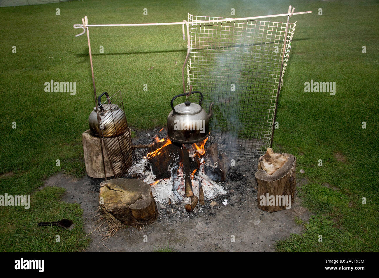 Kettles boiling on camp fire, camp site UK Stock Photo Alamy