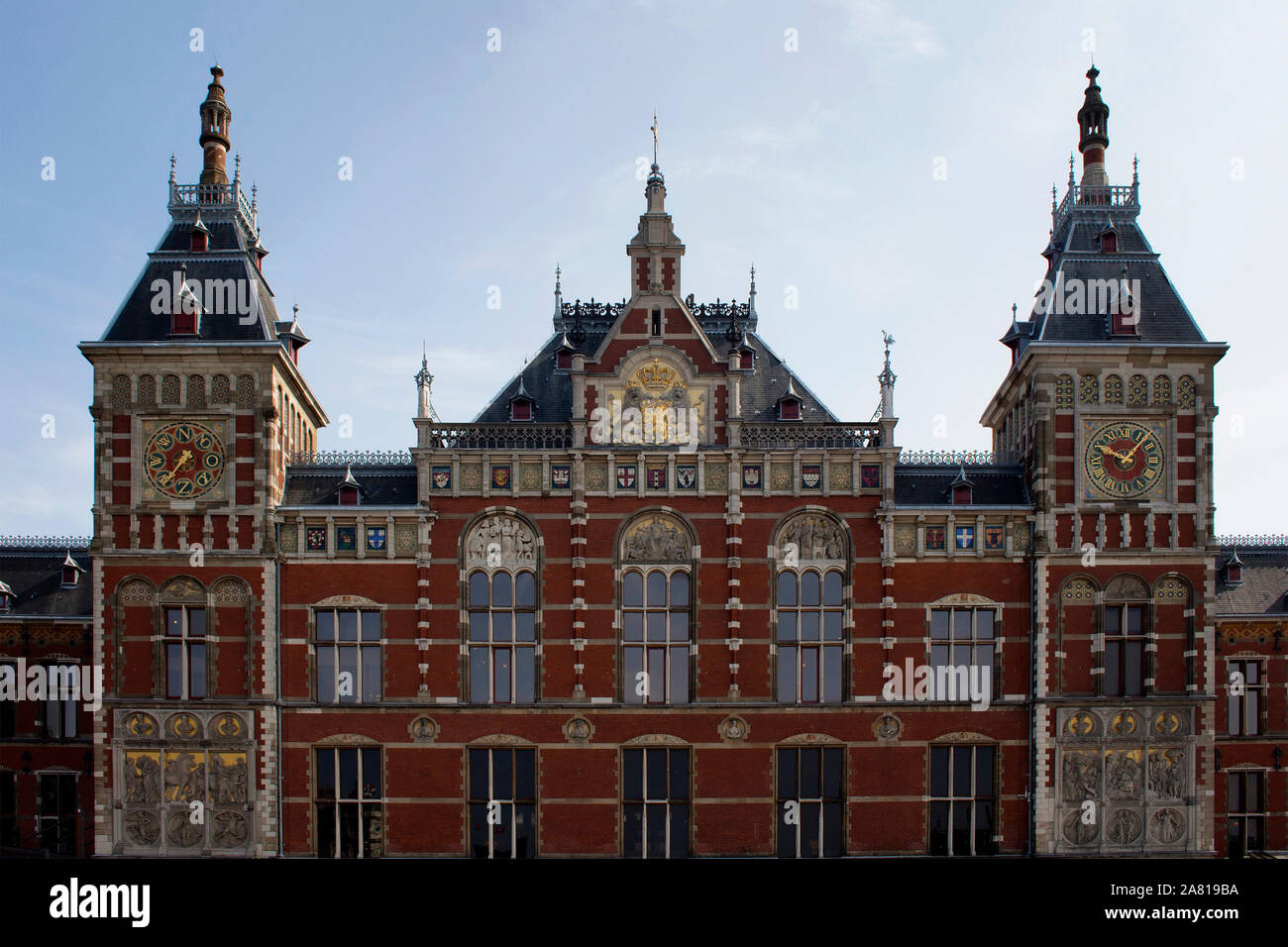 Close up facade view of main train station called Amsterdam Centraal. A major international railway hub, it is used by 162,000 passengers a day. It is Stock Photo
