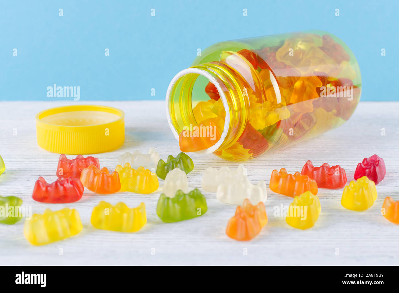 vitamins for children like jelly candy on the table and blue background
