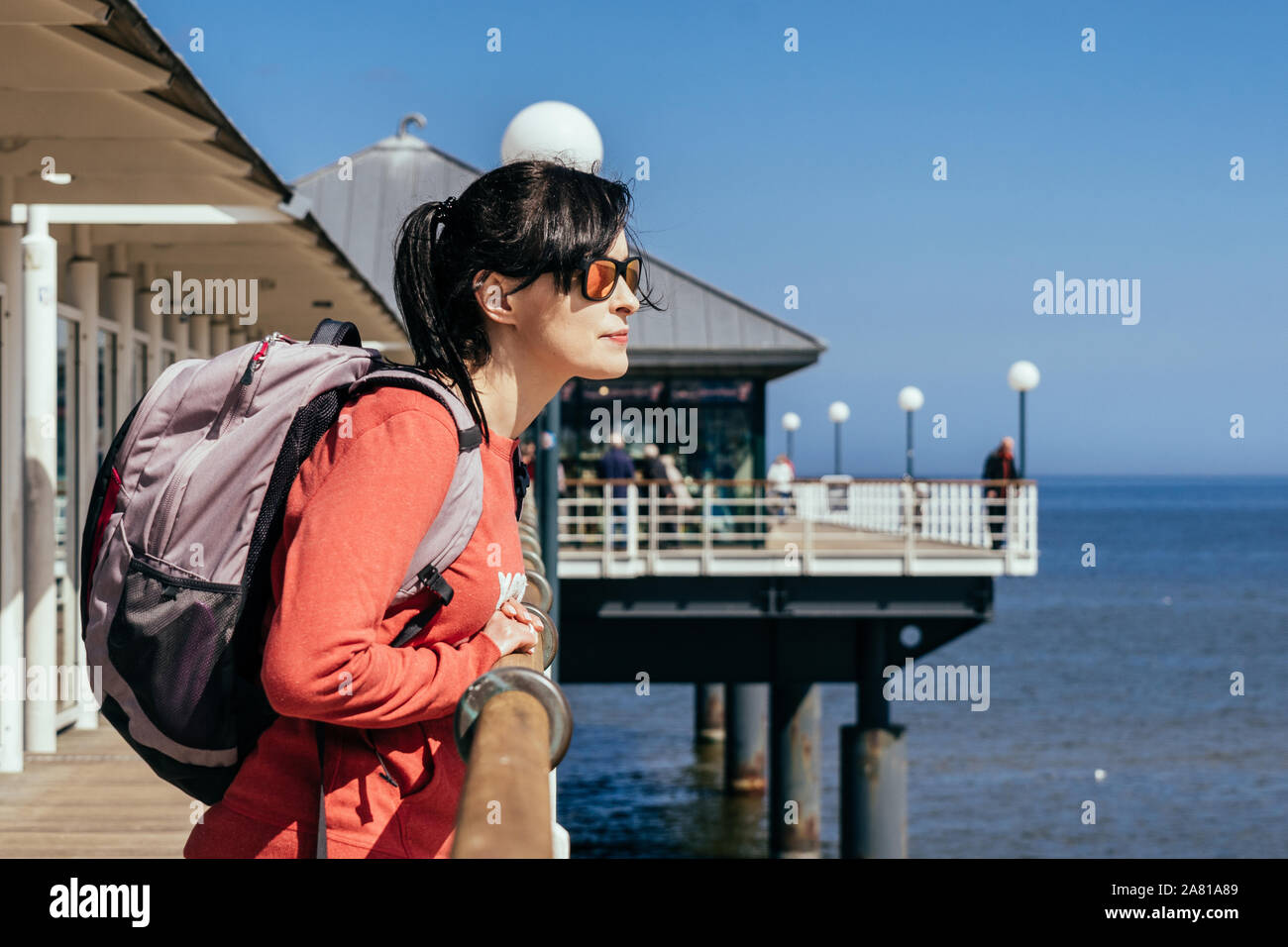 Woman enjoying her time over at the Baltic Sea during autumn and spring seasons. Stock Photo