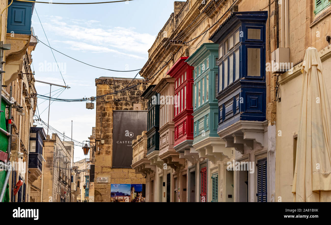 Residential house facade with traditional Maltese multicolored enclosed wooden balconies in Rabat, Malta. Authentic Ma Stock Photo