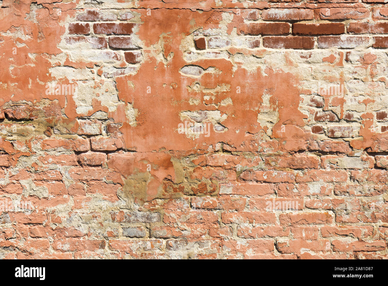 Brick wall pattern. Old wall built from the red bricks with remnants of ...