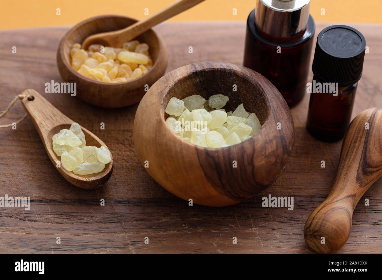 Mastic resin tears. Chios mastic in wooden bowls and essential oil on wood background Stock Photo