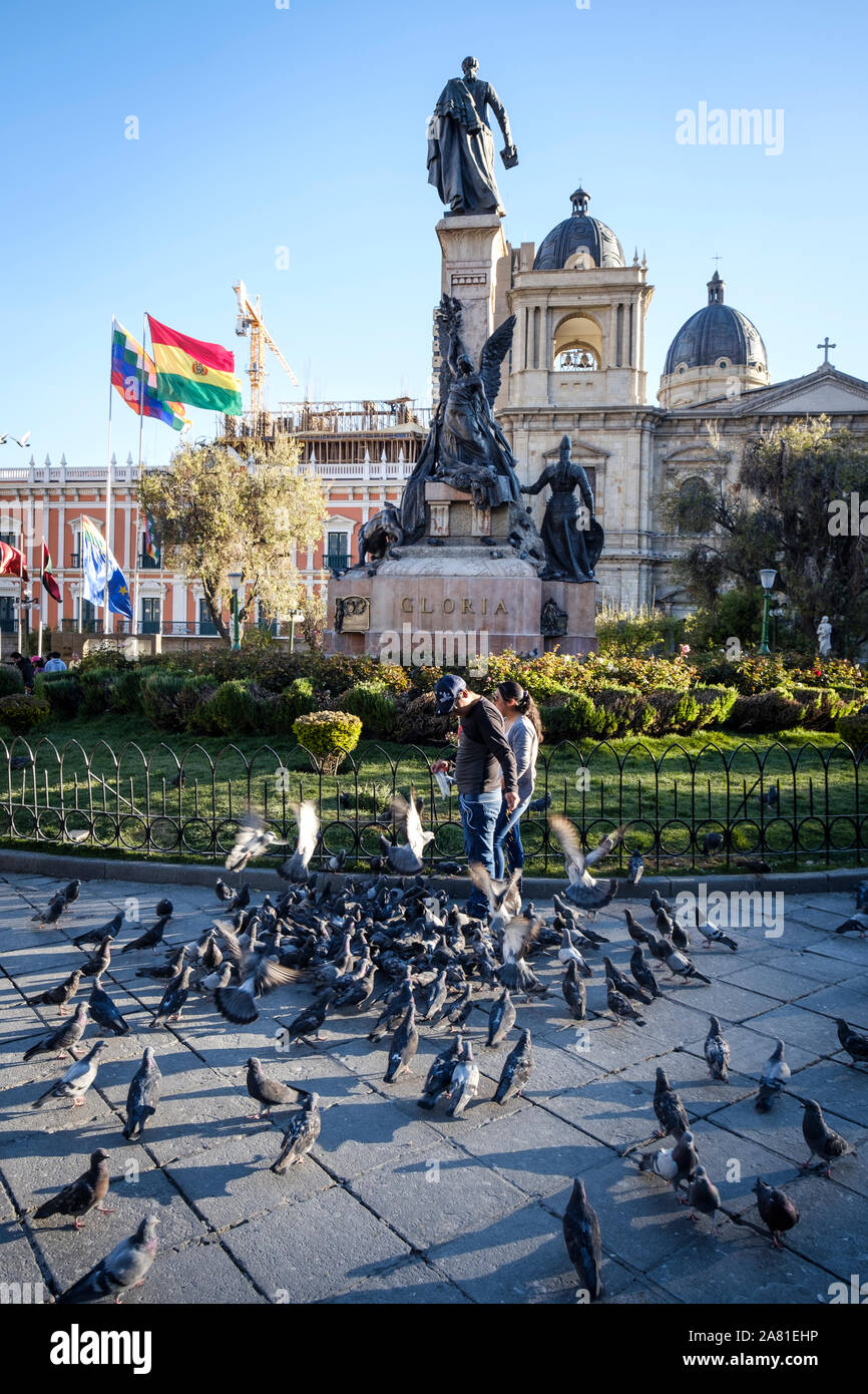 Daily life scene with local people feeding pigeons on the centric Plaza Murillo in the Historic District of La Paz, Bolivia Stock Photo