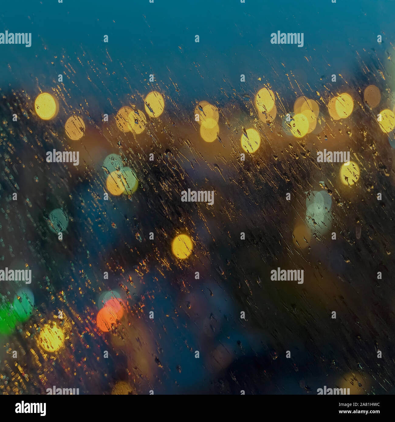 Abstract blurred background of the city night lights rain. Wet window ...