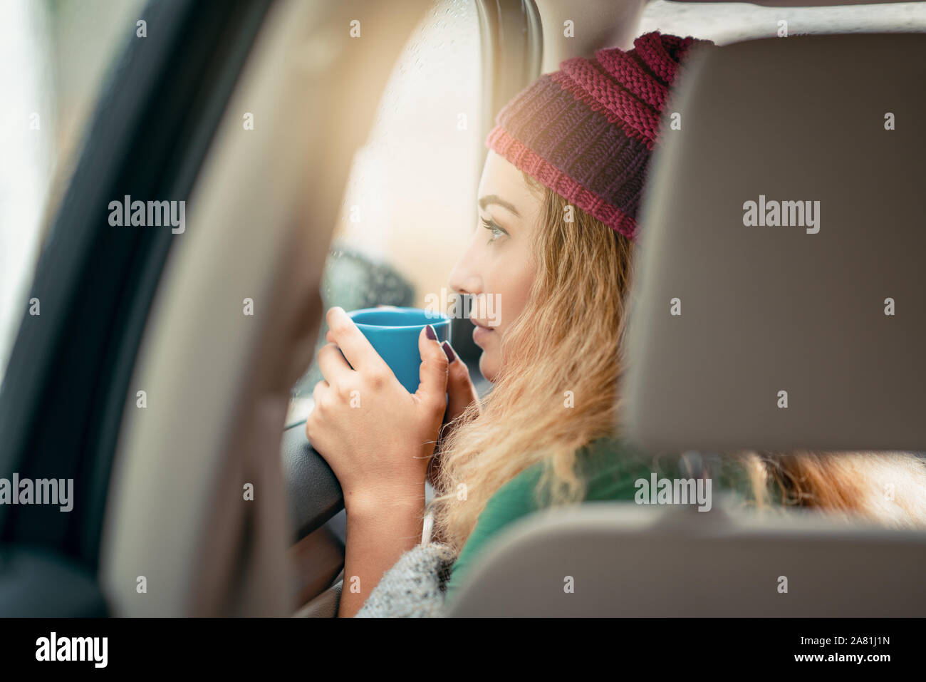 beautiful young woman looking to the outside from car. Stock Photo