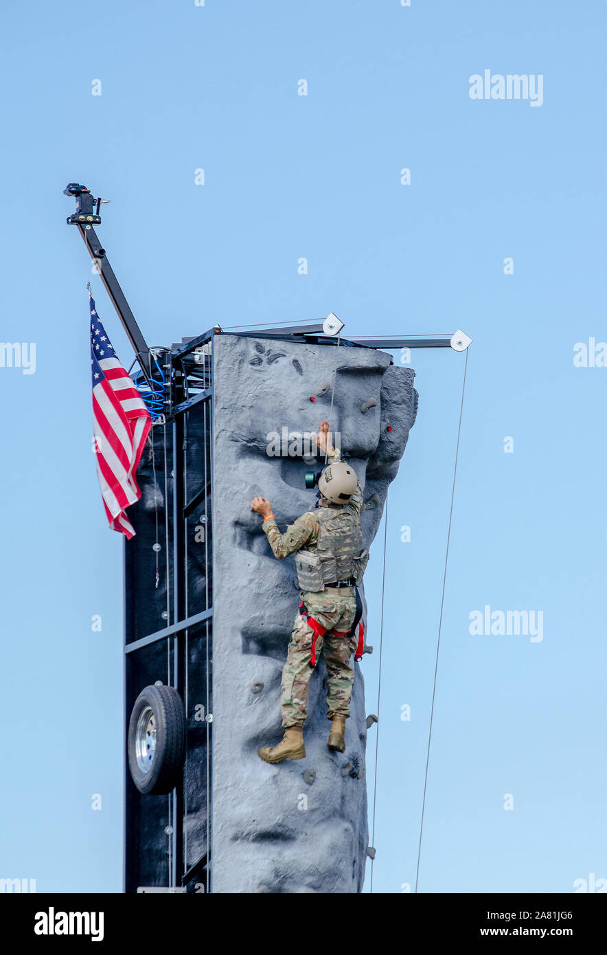 Kalamazoo Michigan USA July 3 2017; an army soldier demonstrates tactical scaling of a tall climbing wall, to show  the challenges faced by military Stock Photo