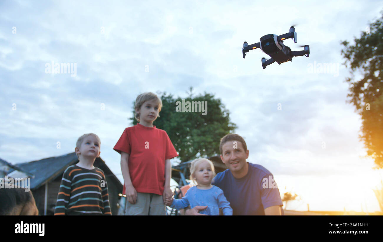 Children are watching the flying drone Stock Photo Alamy