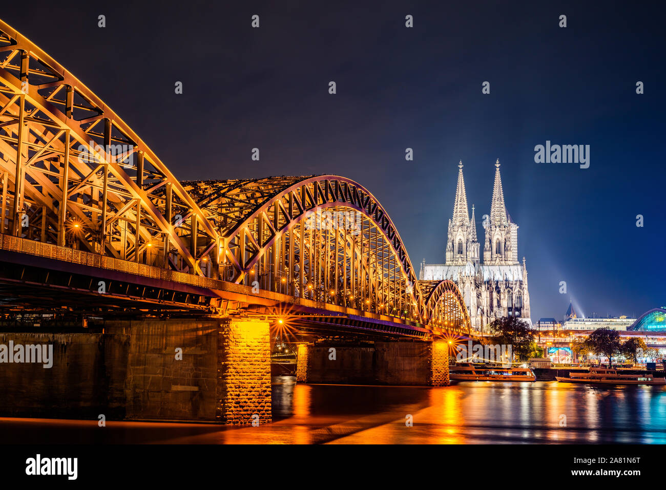 The city of Cologne at night with Cologne Cathedral, Hohenzollern Bridge and Rhine river Stock Photo