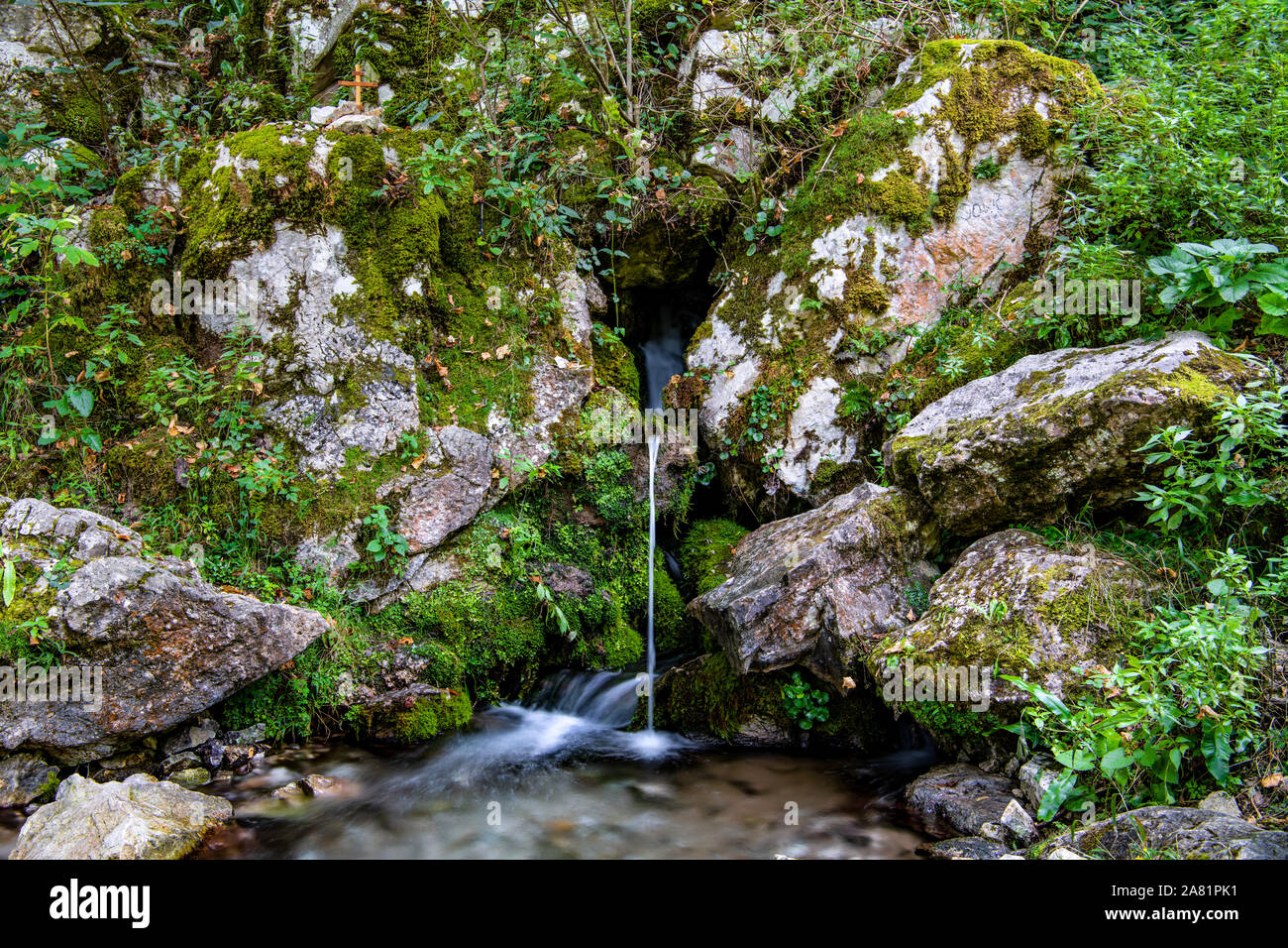 Beautiful waterfall, river Raca, spring Ladjevac, rocks covered with dense green moss, fresh water, and air on Mount Tari, on the footpath Stock Photo