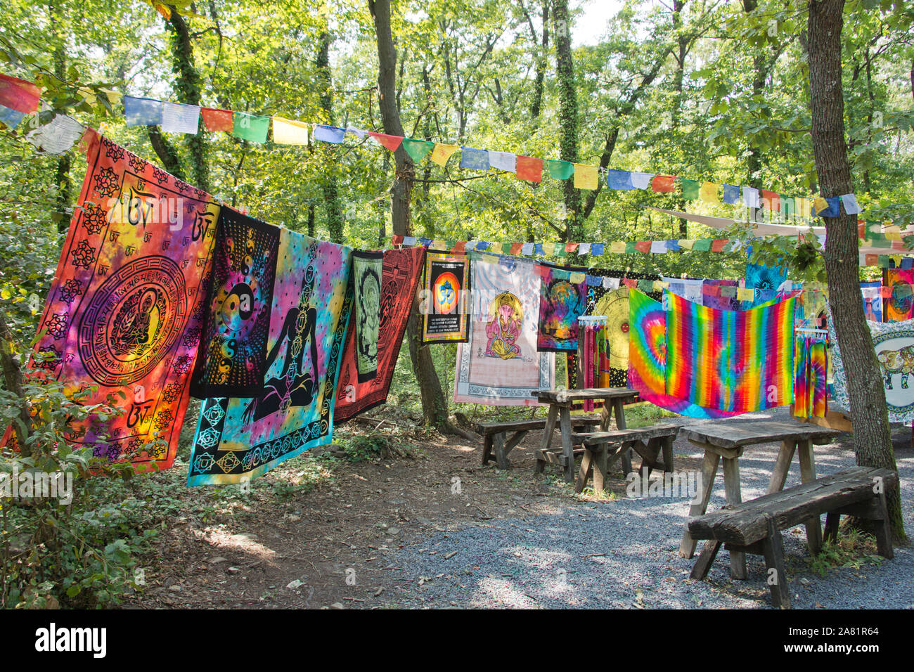 Colorful batik cloths hanging on a clothesline in the forest Stock Photo